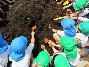 シャベルで土を掘っている園児たちの写真